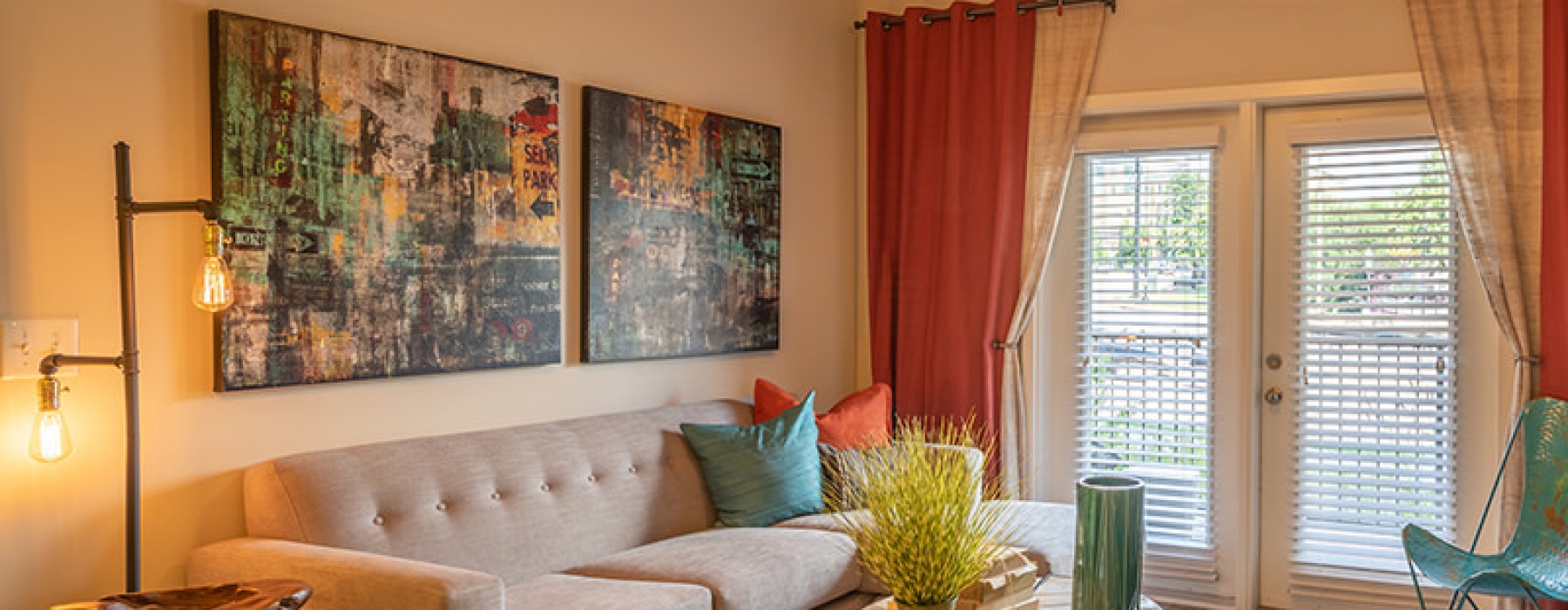 Living room with wood floors and double doors that lead to a patio