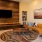 Resident lounge area with comfortable seating, a wooden wall, and tiled flooring at Trailside at Reedy Point Apartments