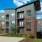Exterior view of apartment building with brick sign next to it at Trailside at Reedy Point in Greenville, SC
