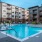 Swimming pool with lounge chairs all around at Trailside at Reedy Point Apartments