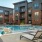Lounge chairs on pool deck at Trailside at Reedy Point Apartments