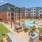 Community courtyard area with grills and swimming pool at Trailside at Reedy Point Apartments